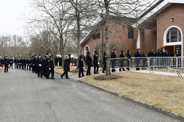 Officers enter St. Rosalie's Church in Hampton Bays Wednesday morning. DANA SHAW
