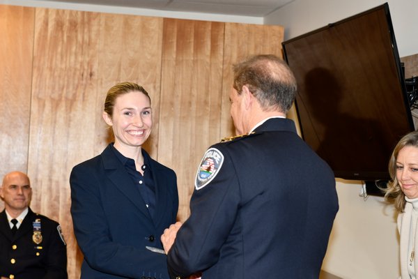Officer Caryl Pfeiffer shakes Southampton Town Police Chief Steven Skyrnecki's hand after being sworn in.