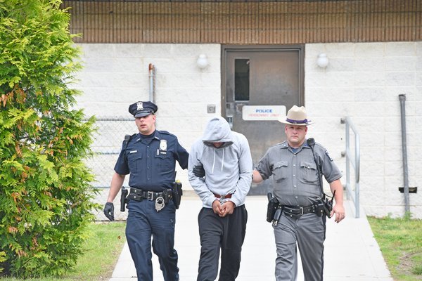 Chace Quinn is led by Southampton Town and State Police to his arraignment on Tuesday morning.  DANA SHAW