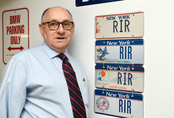 Robert Ross with some of his “RIR” vanity plates.  DANA SHAW