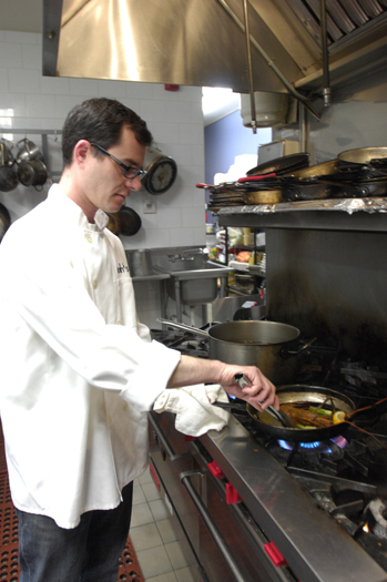  prepares a dish in his restaurant in Greenport.