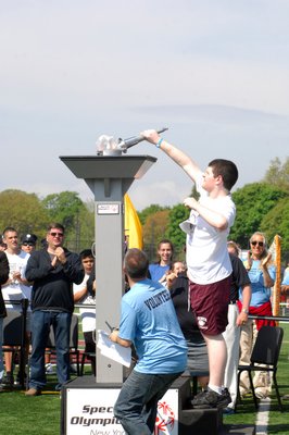 Trevor Dillon of Southampton lights the torch and opens the games.