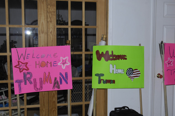 Signs welcoming Marine Truman Cowell home.