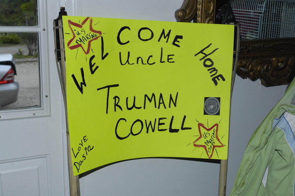 Signs welcoming Marine Truman Cowell home.
