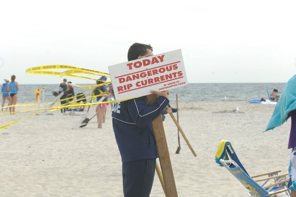 Lifeguards post signs warning of dangerous rip currentls.  DANA SHAW