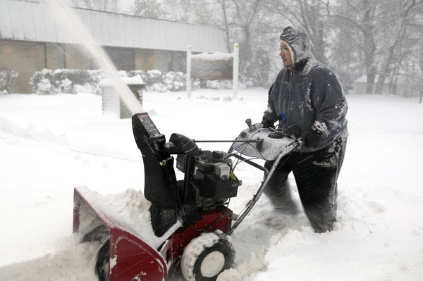 Jim O'Connell clears snow early on Wednesday morning in Hampton Bays.   DANA SHAW