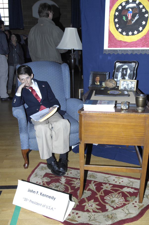 Sam Warne as John F. Kennedy.