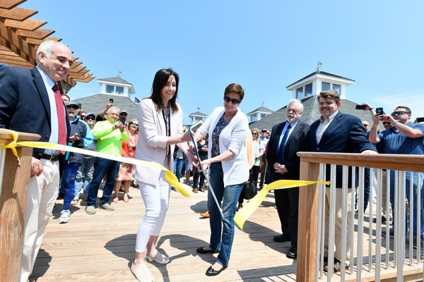 Southampton Town Parks Department Director Kristen Doulos and Town councilwoman Julie Lofstad cut the ribbon at the Ponquogue Beach pavilion on Monday.  DANA SHAW