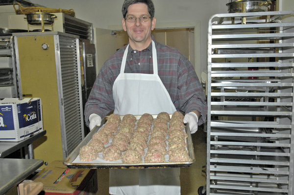 Rotarian Mike Hadix with a tray of meatballs. DANA SHAW