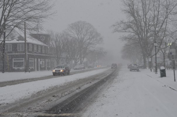 The snow piles up in East Hampton Village on Tuesday afternoon. SHAYE WEAVER