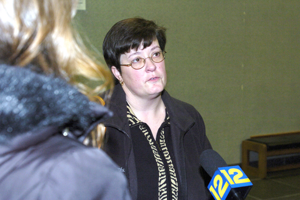 Stacey Reister speaks with the press outside of the courtroom.