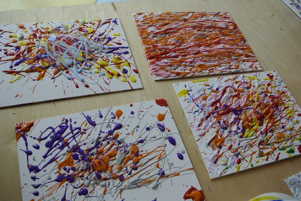 Children work on drip paintings at CMEE on Saturday.