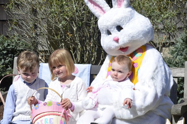 Liam and Abigail Beckert and Claire Dorn with the Easter Bunny at the LVIS Easter Egg Hunt on Saturday. SHAYE WEAVER