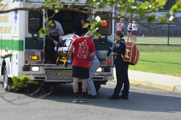 A person is loaded into a Suffolk County Police medevac helicopter at the Westhampton Beach High School following a two-car crash on Old Riverhead Road on Thursday afternoon. BY ERIN MCKINLEY