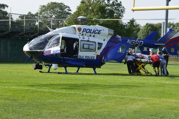 A person is loaded into a Suffolk County Police medevac helicopter at the Westhampton Beach High School following a two-car crash on Old Riverhead Ro