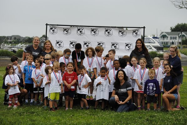 Raynor Country Day School and Summer Camp hold up their medals for completing the Kids Fun Run. DANIELA DETORE