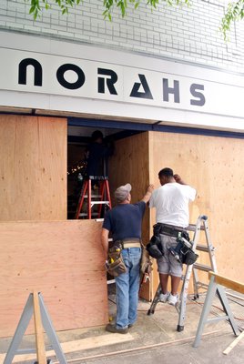 A crew works to board up Norahs on Jobs Lane on Thursday after an SUV crashed into the front of the store on Wednesday evening. BY DANA SHAW