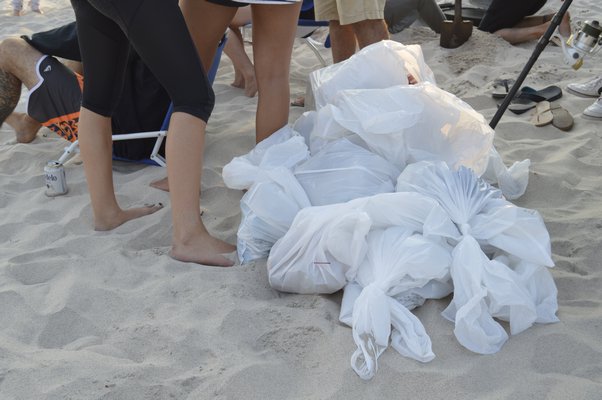  at a beach cleanup at Flying Point Beach in Water Mill Monday evening. ALYSSA MELILLO