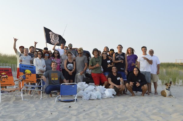 Volunteers at Worldwide Psychos' beach cleanup at Flying Point Beach in Water Mill Monday evening. ALYSSA MELILLO
