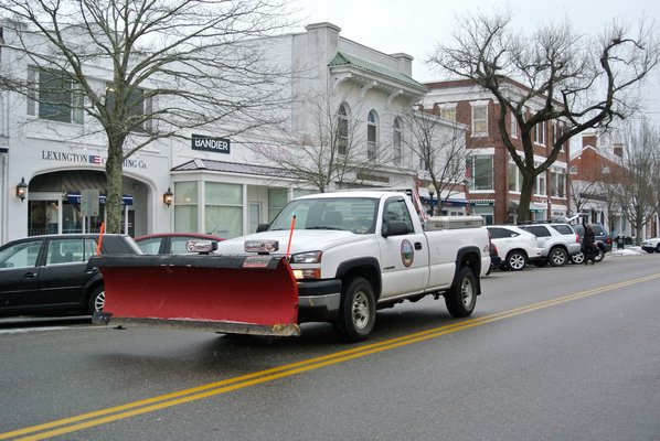Snow plows muster for the impending storm on Monday morning in Southampton Village.  DANA SHAW