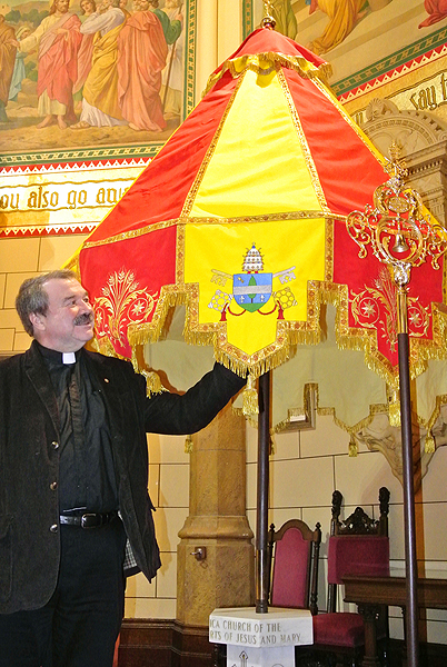 Father Mike Vetrano with the ombrellino in the Basilica of Sacred Hearts of Jesus and Mary in Southampton. TWhenever a pope visits a basilica