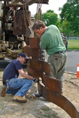 Dean Foster and Ray Topping Jr. work to put the memorial in place on Wednesday