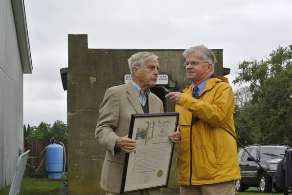 Assemblyman Fred W. Thiele Jr. presents a proclamation to Bridgehampton Museum President Walter R. Miller.