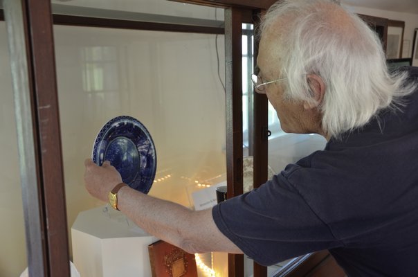 East Hampton Village Historian and Director of Home Sweet Home Hugh King holds a blue Staffordshire plate