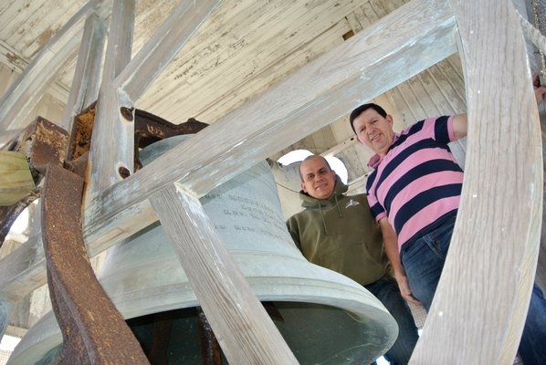 Pastor Adrian Garcia and Herbert Sequeirain the bell tower at the Southampton United Methodist Church.  DANA SHAW