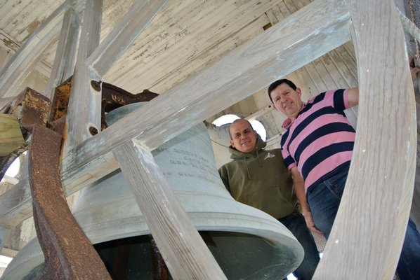 Pastor Adrian Garcia and Herbert Sequeirain the bell tower at the Southampton United Methodist Church.  DANA SHAW