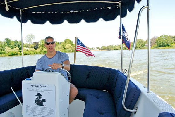 Nicholas Palumbo pilots the Concer Ferry on Lake Agawam.  DANA SHAW