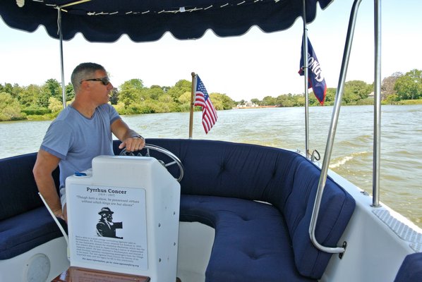 Nicholas Palumbo pilots the Concer Ferry on Lake Agawam.  DANA SHAW