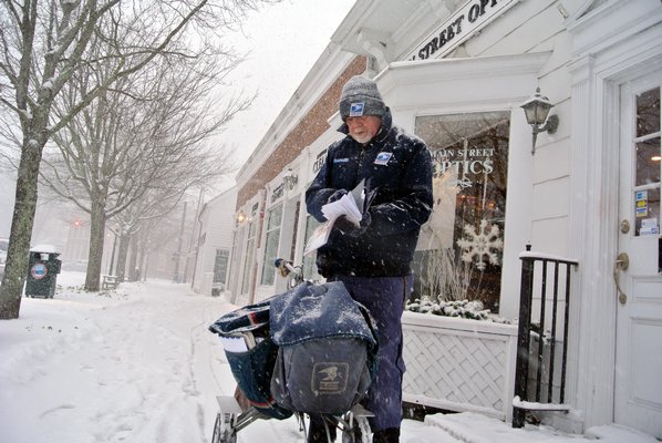 Mail Carrier Jim Tuthill makes his rounds in Southampton Village On Tuesday afternoon.  DANA SHAW