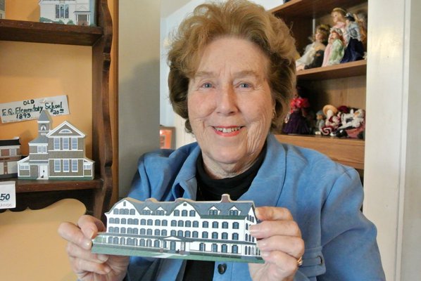  president ot the East Quogue Historical Society with one of the historical wooden figurines.  DANA SHAW
