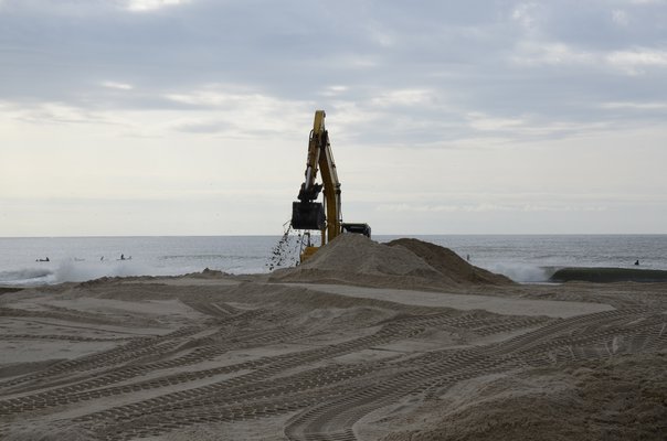 Heavy machinery is used to dig a trench between Mecox Bay and the Atlanti Ocean. GREG WEHNER