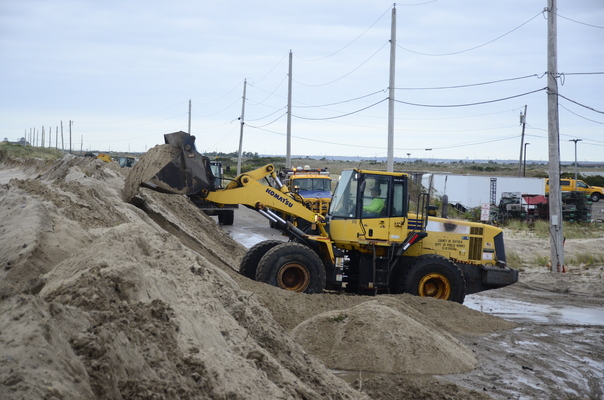 County and state crews helped rebuild a nearly 100-yard dune that was breached during a nor'easter on Thur
