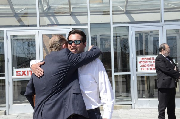  walks out of Suffolk County 1st District Court in Islip with his attorney Colin Astarita on Tuesday