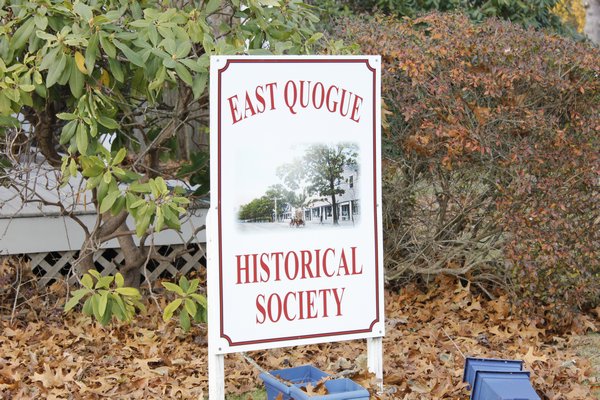  president ot the East Quogue Historical Society with one of the historical wooden figurines.  DANA SHAW