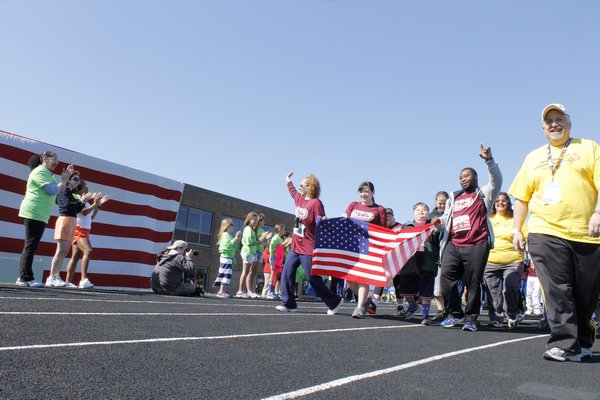 Special Olypmians walk onto the Southampton High School track during the opening ceremony Sunday morning. KYLE CAMPBELL