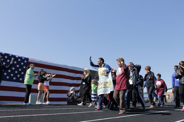 Special Olypmians walk onto the Southampton High School track during the opening ceremony Sunday morning. KYLE CAMPBELL