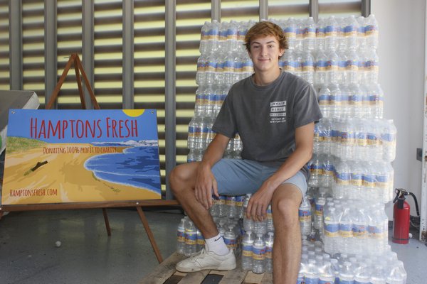 Adam Jannetti stores pallets of Hamptons Fresh water in the garage of his Sag Harbor home. VALERIE GORDON 