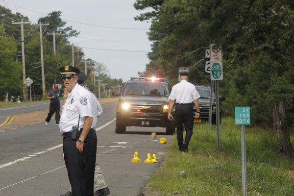 Southampton Town Police lieutenants Michael Zarro and James Kiernan on the scene of a roll-over car accident on Flanders Road in Flanders. KYLE CAMPBELL
