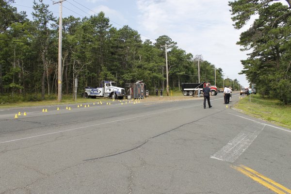 Southampton Town Police block off Flanders Road near Red Creek Road in Flanders on Thursday morning following a roll-over accident between a tractor-trailer and a Toyota Corolla. KYLE CAMPBELL