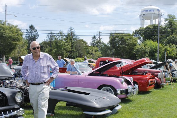 Sag Harbor resident Stan Listokin checks out the array of cars on discplay at the Hampton Bays Fire Department Car Show on Saturday. KYLE CAMPBELL