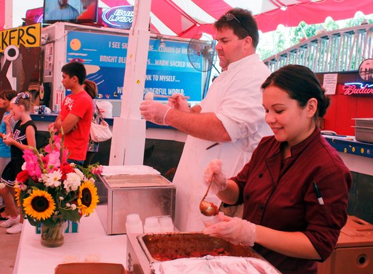 The Cowfish team serves up their clam chowder and chili during the 16th annual Hampton Bays Chamber of Commerce Chili/Chowder Contest on Sunday afternoon at the Boardy Barn in Hampton Bays. KYLE CAMPBELL