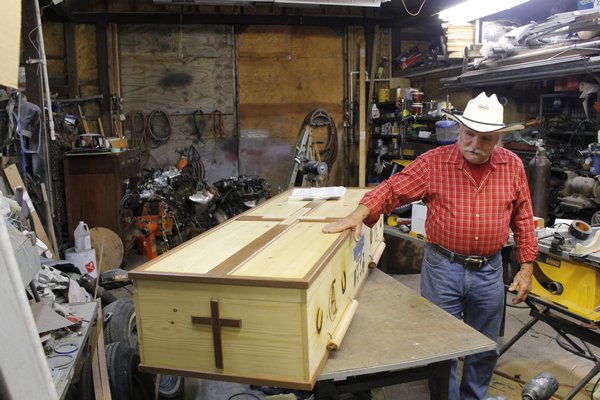 East Quogue resident Ron Campsey with the casket he built for his dying father in the workshop behind his home. KYLE CAMPBELL