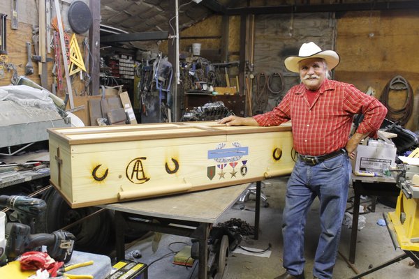 East Quogue resident Ron Campsey with the casket he built for his dying father in the workshop behind his home. KYLE CAMPBELL