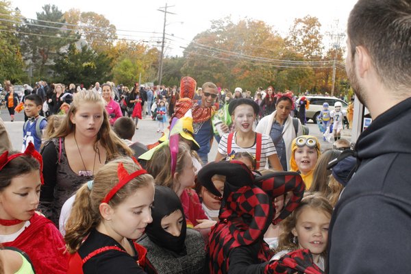 Children rush to collect candy along Mill Road during the Westhampton Beach Halloween parade Friday afternoon. KYLE CAMPBELL