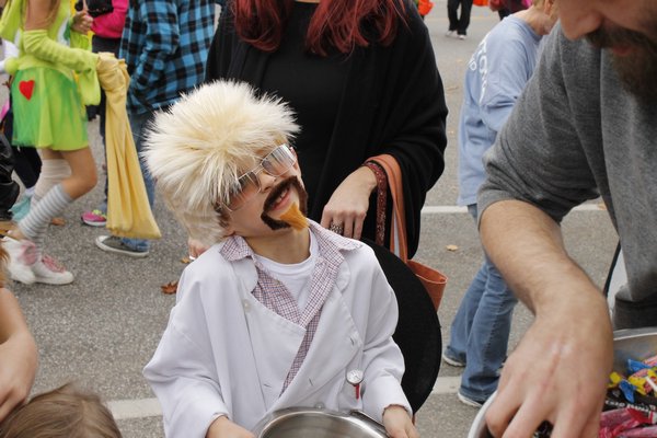 A boy dressed as Food Network star Guy Fieri waits for candy outside Justin's Chop House on Mill Road during the Westhampton Beach Halloween parade Friday afternoon. KYLE CAMPBELL