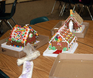 left and Nora Davenport of East Quogue organized a gingerbread house-making group at Westhampton Beach High School on Friday. The houses will be donated to families in need. JESSICA DINAPOLI